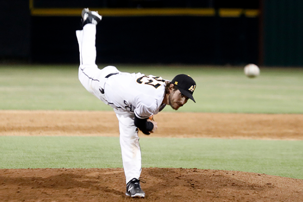 Image of a Cal State LA pitcher on the mound, mid-throw. 